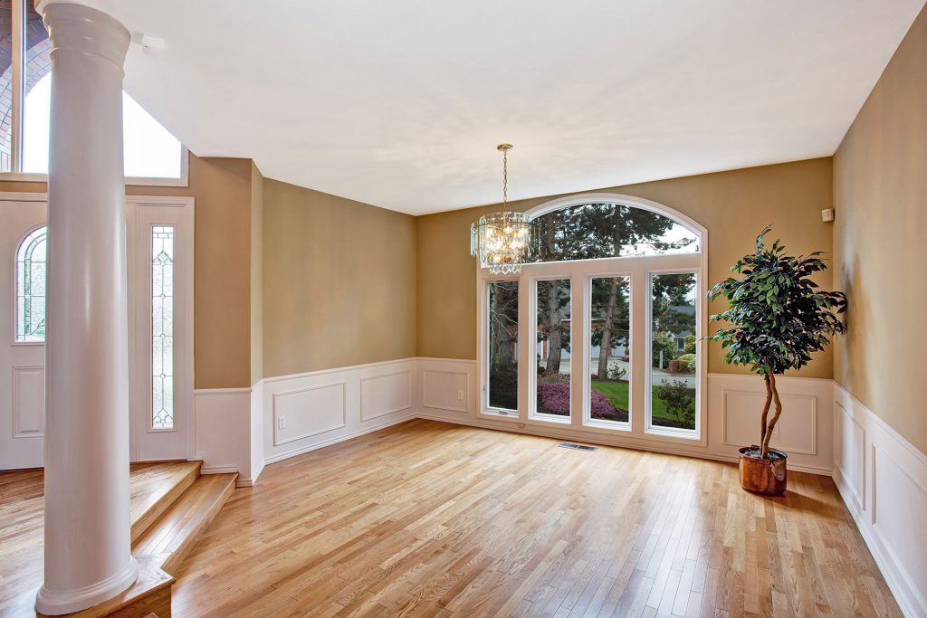 Room with hardwood floors and a large window for natural light