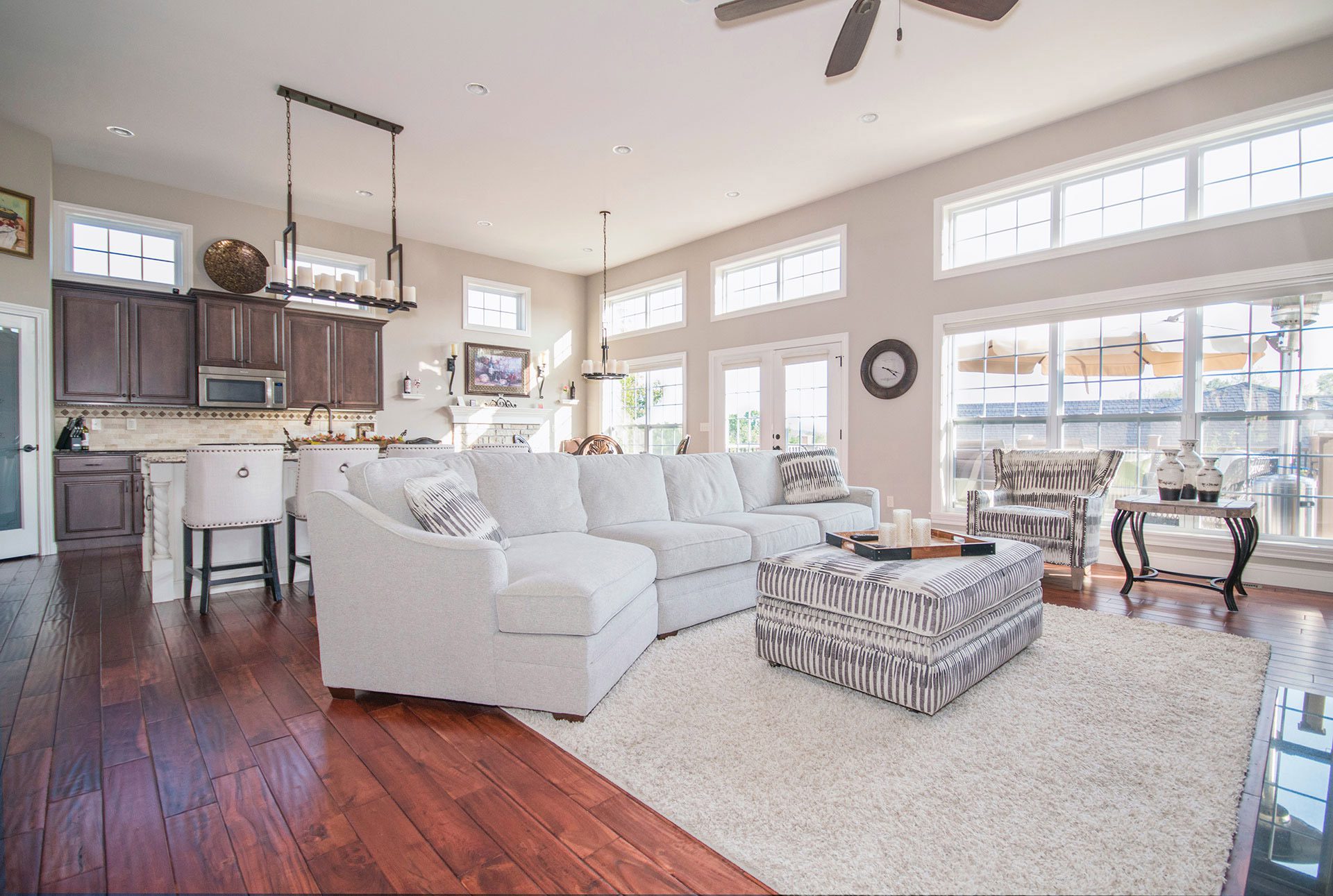 A cozy living room with hardwood floors and a ceiling fan.