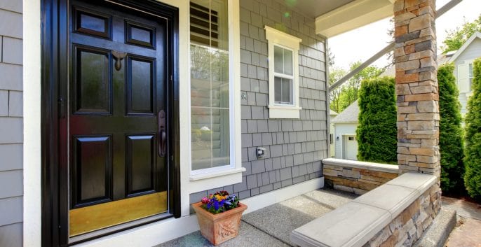 Exterior view of a house featuring a striking black and yellow door