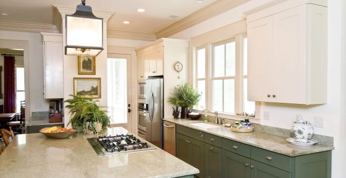 Green kitchen cabinets and white countertops